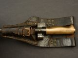 an old gun with a brass handle on a black surface