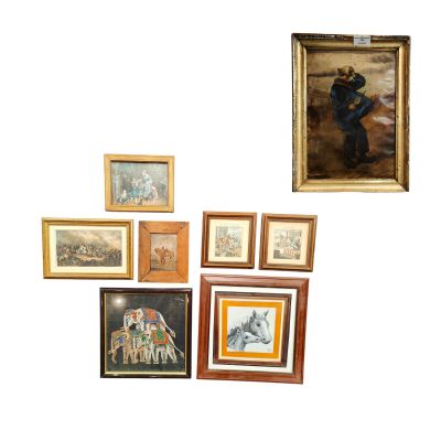 a lot of framed pictures on the wall of this room