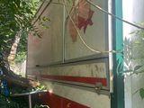 a red and white trailer that is parked in the woods