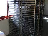 many trays of food that are sitting on a rack