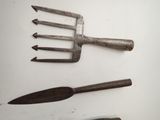 three old tools that are laying on a white surface