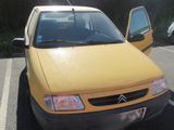 a yellow car that is parked in a parking lot