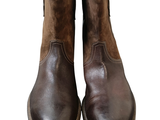 pair of brown leather boots on a white background with a white background