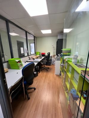 a room with a lot of desks and chairs in it