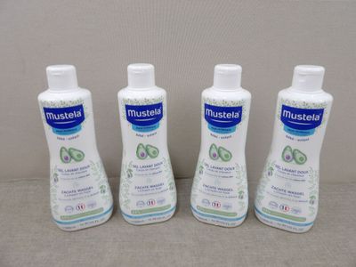 three bottles of mouthwash sitting on a table next to each other