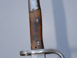 a close up of a knife with a wooden handle