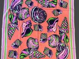 pink, green, and purple scarf with shells on a pink background