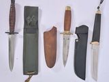several different types of knives are lined up on a white surface