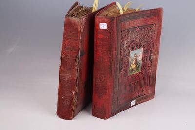 pair of red leather books with pictures of a man and a woman on them