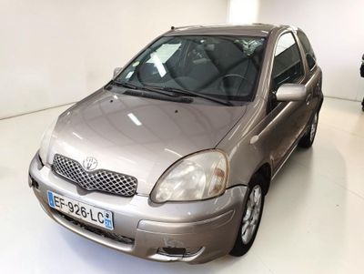 a silver car that is parked in a white room