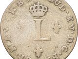 a close up of a coin with a crown on it