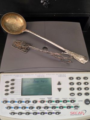 a scale with a spoon and a measuring spoon on top of it