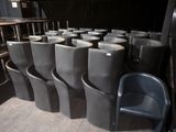 many chairs that are lined up in a row
