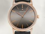 a close up of a wrist watch with a black dial on a black leather strap