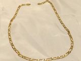 a gold chain necklace on a white background