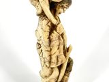 an antique ivory figurine of a man holding a fish