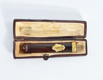 a pen that is in a case on a white surface