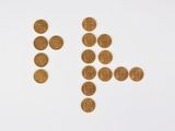 an image of a number of gold coins on a white surface