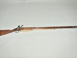 a rifle with a wooden barrel and a wooden handle