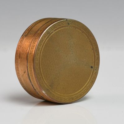 a close up of a small metal object on a white surface