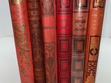 a set of five red books sitting on top of each other