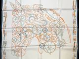 an orange and white square scarf with a drawing of a motorcycle on it