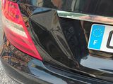 a close up of a car ' s license plate on the back of the car