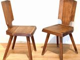 two wooden chairs sitting next to each other on a hard wood floor