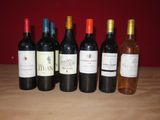 plusieurs bouteilles de vin sont alignées sur une table en bois