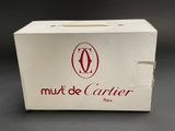 white box with a red logo on it sitting on a black surface