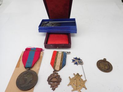 an assortment of medals and medals are displayed on a table