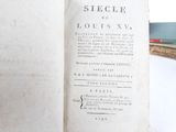 an old book that is open on a table