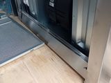 someone is opening the door of a stainless steel oven with the door open