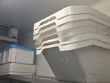 a stack of containers sitting on a shelf in a room