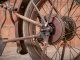 a close up of a motorcycle wheel with a brick wall in the background