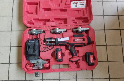 a red tool case with tools in it on a tiled floor