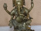 brass statue of an elephant sitting on top of a turtle