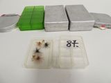 a box of flies and a tin of tins on a table