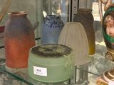 de nombreux vases et assiettes exposés dans une vitrine