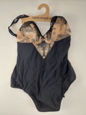 an image of a black and tan one piece swimsuit on a hanger