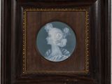 portrait of a woman in profile in a dark wood frame