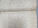 an old document with writing on it sitting on top of a table