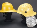 two yellow hard hats are sitting next to each other on a mannequin head