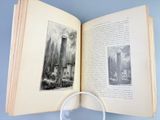 an open book with a magnifying glass on top of it