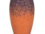 a blue and orange vase sitting on a white surface
