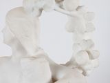 statue of a woman holding a wreath of flowers in her hands