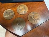 three coins on a table next to a laptop