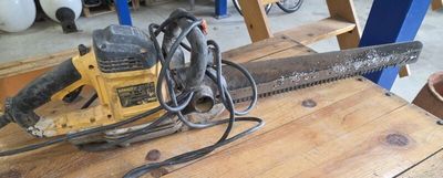 a chainsaw sitting on a wooden table in a workshop