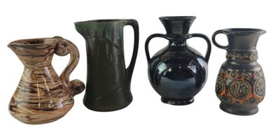 four different vases sitting next to each other on a white surface