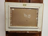 an old wooden easel with a painting on top of it